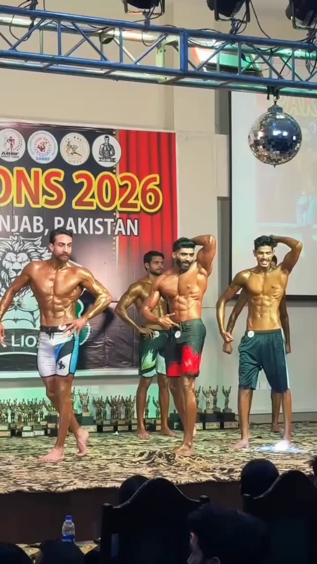 Haris Anjum on stage at a 2026 bodybuilding championship in Punjab, Pakistan